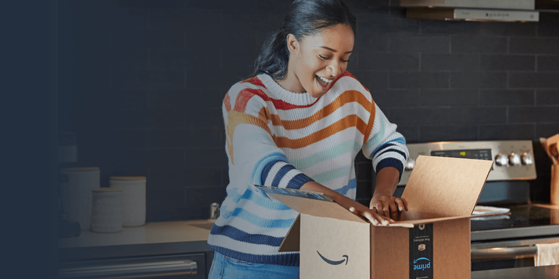 Smiling person in kitchen opening a package delivery