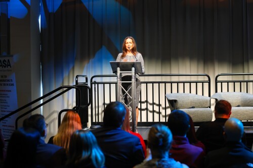 Image of Head of External Relations for Customer Experience Integrity at Amazon, Abigail Bishop, speaking to summit attendees.