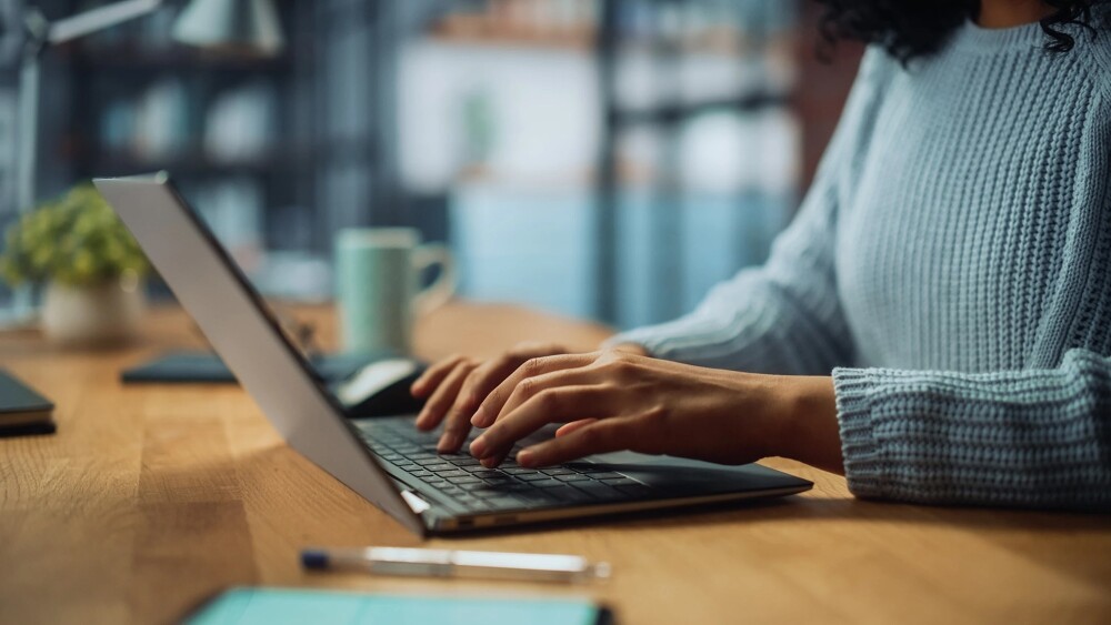 Closeup of person's hands typing on a laptop computer